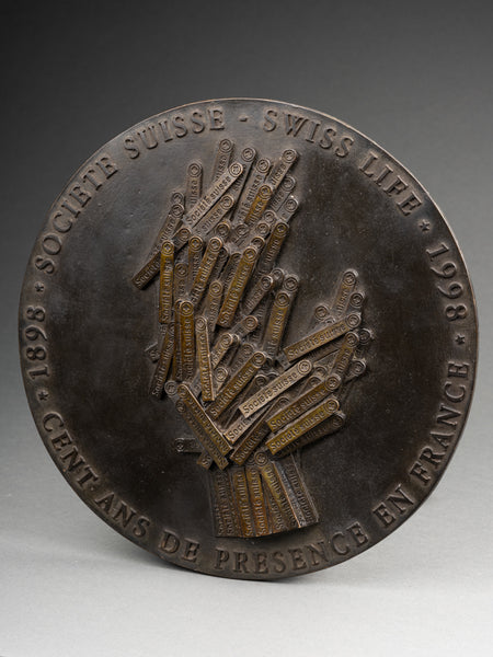 ARMAN 'La Main Tendue' - Patinated bronze medallion