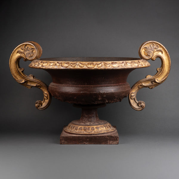 Large pair of patinated and gilded cast iron planters from the late 19th/early 20th century.