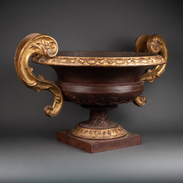 Large pair of patinated and gilded cast iron planters from the late 19th/early 20th century.