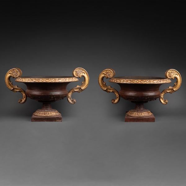 Large pair of patinated and gilded cast iron planters from the late 19th/early 20th century.