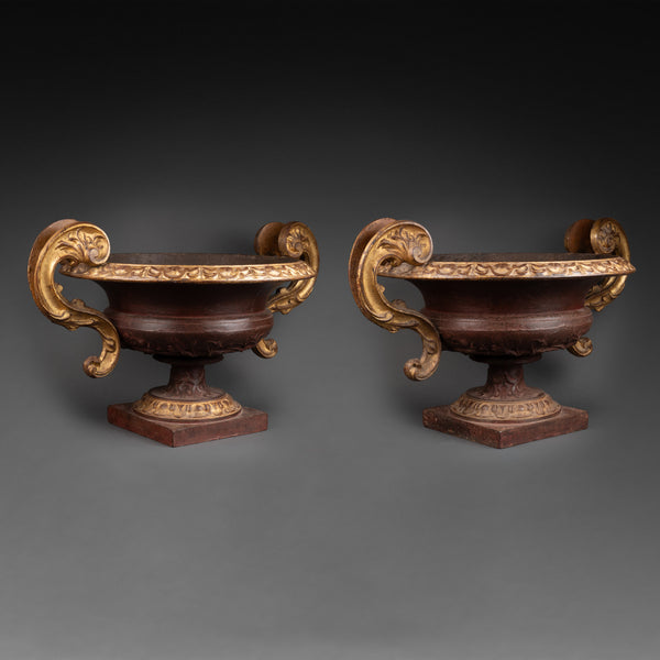 Large pair of patinated and gilded cast iron planters from the late 19th/early 20th century.