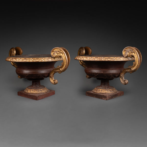 Large pair of patinated and gilded cast iron planters from the late 19th/early 20th century.