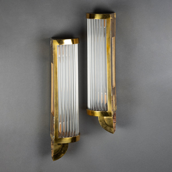 Pair of Art Deco wall sconces with golden metal bases and glass tubes