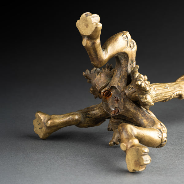 Pair of gilded bronze candlesticks, decorated with lizards, lions, and bunches of grapes, late 19th century.