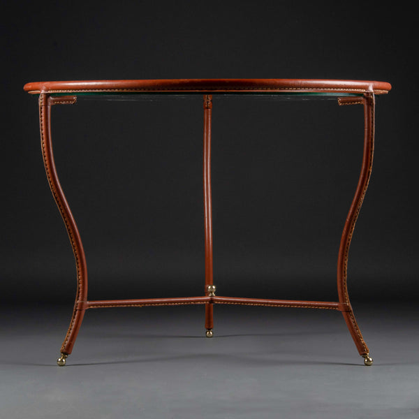 Jacques ADNET (1900-1984) Small round tripod coffee table in brown stitched saddle leather, circa 1950.